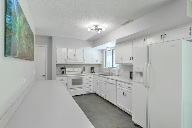 kitchen with white appliances, sink, a textured ceiling, and white cabinets