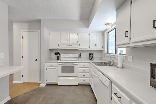 kitchen with sink, a textured ceiling, white cabinets, and white appliances