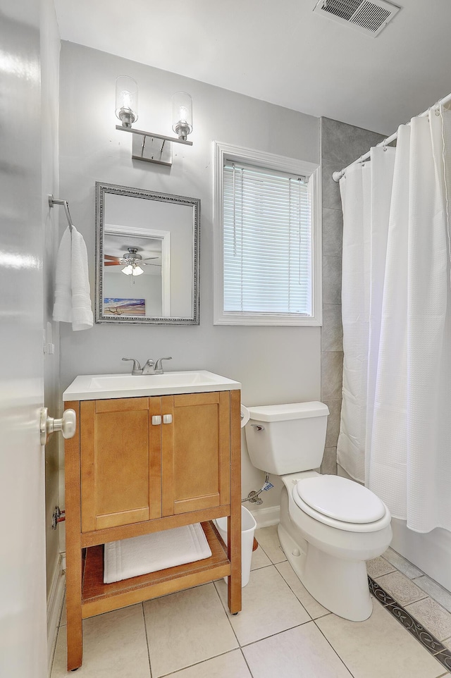 bathroom featuring a shower with curtain, vanity, toilet, and tile patterned flooring