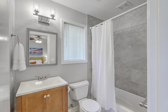 full bathroom with shower / tub combo with curtain, vanity, and toilet