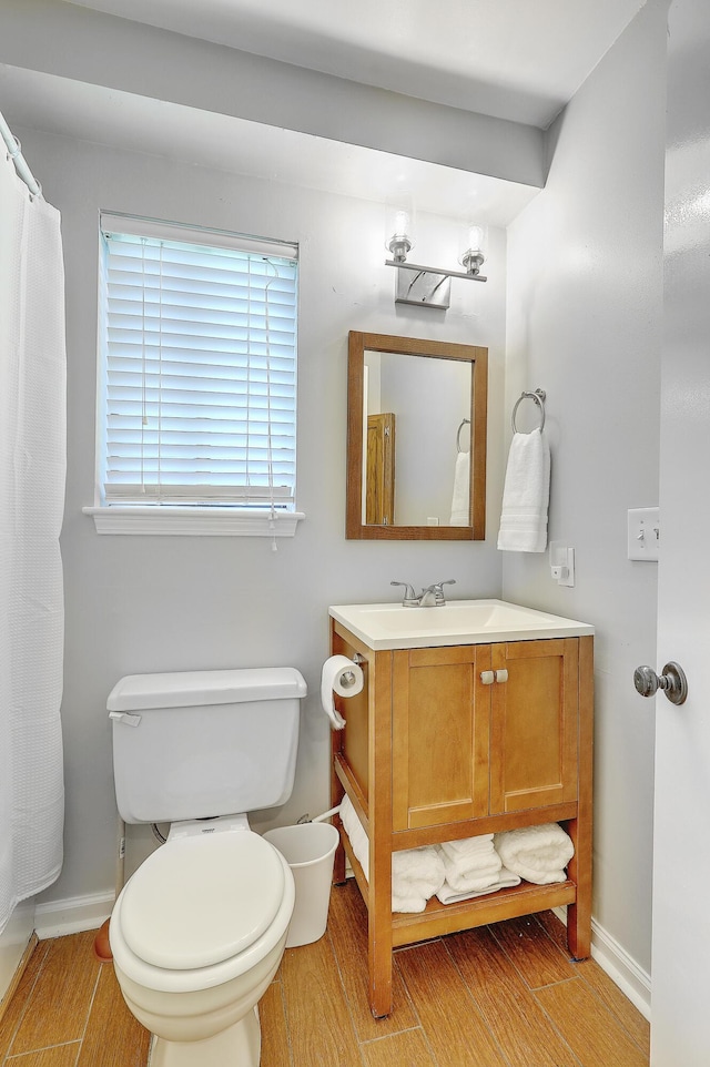 bathroom with vanity, hardwood / wood-style flooring, and toilet