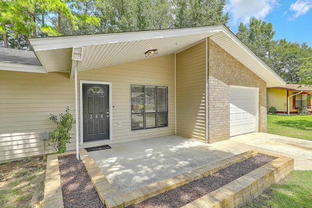 view of exterior entry with a garage