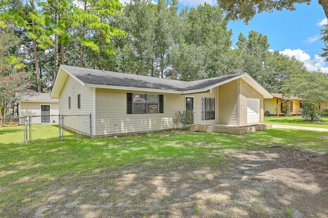 ranch-style home featuring a garage and a front lawn