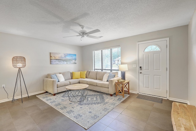 tiled living room with a textured ceiling and ceiling fan