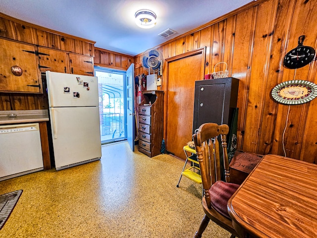 kitchen with wooden walls and white appliances