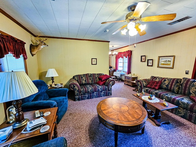 carpeted living room featuring ornamental molding and ceiling fan with notable chandelier