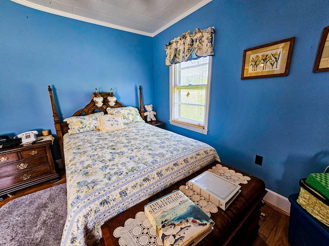 bedroom with wood-type flooring and crown molding