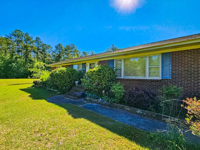 view of side of property featuring a yard