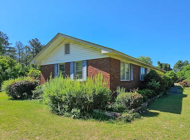 view of home's exterior with a yard