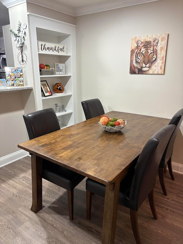 dining space with washer / dryer, ornamental molding, wood-type flooring, and built in shelves