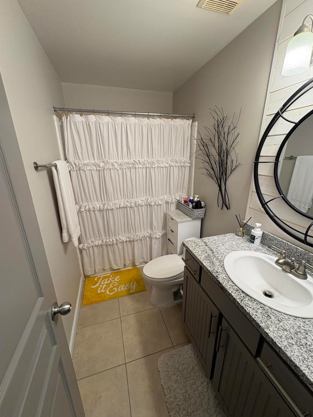 bathroom featuring vanity, toilet, a shower with shower curtain, and tile patterned flooring