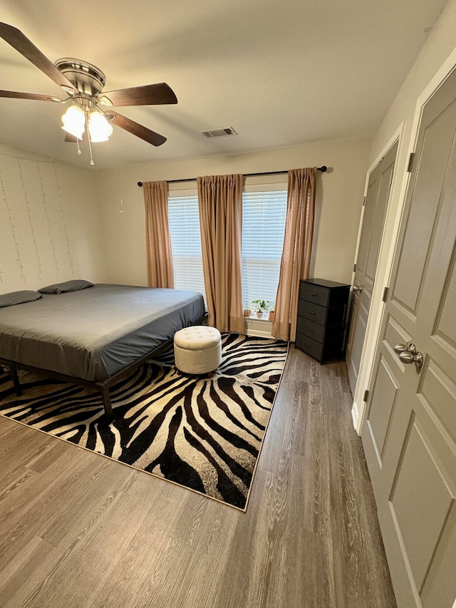 bedroom with hardwood / wood-style floors and ceiling fan