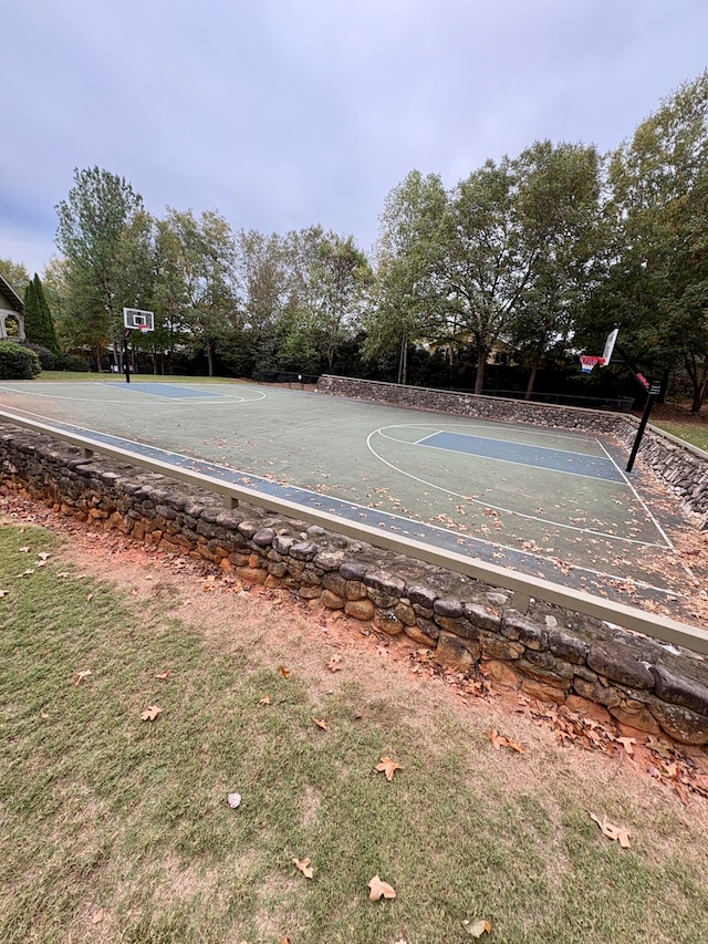 view of basketball court with a lawn