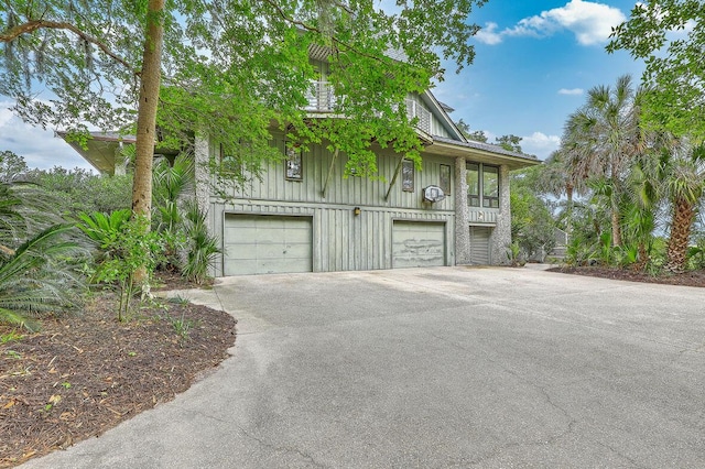 2287 Shoreline Dr, Johns Island, SC 29455 - view of front of property featuring driveway, an attached garage, and board and batten siding
