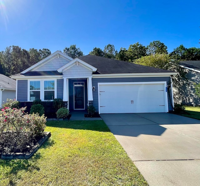 view of front of house featuring a front yard and a garage