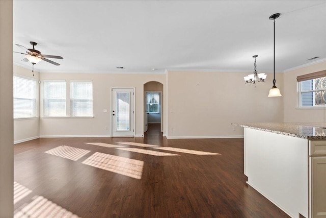 unfurnished living room with crown molding, dark hardwood / wood-style floors, and ceiling fan with notable chandelier