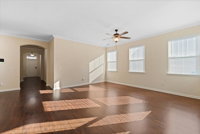 unfurnished room with crown molding, ceiling fan, and dark hardwood / wood-style flooring