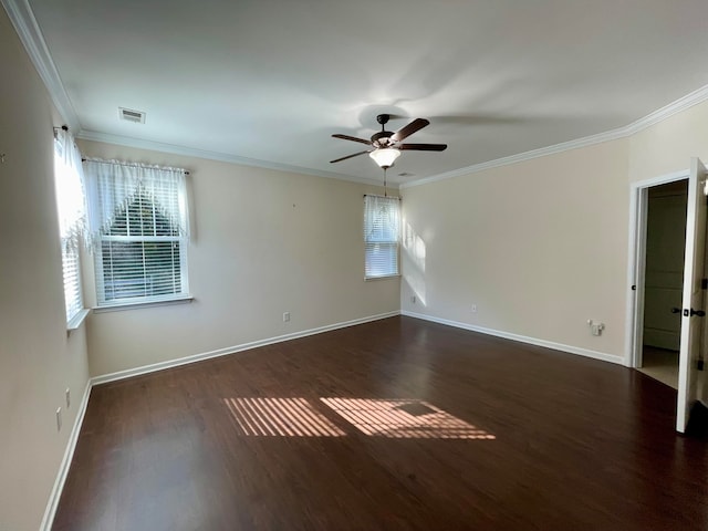 empty room with ornamental molding, dark wood-type flooring, and ceiling fan