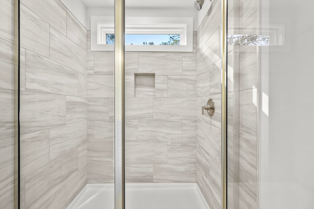 bathroom with a shower with door