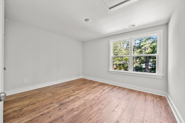 spare room featuring wood-type flooring