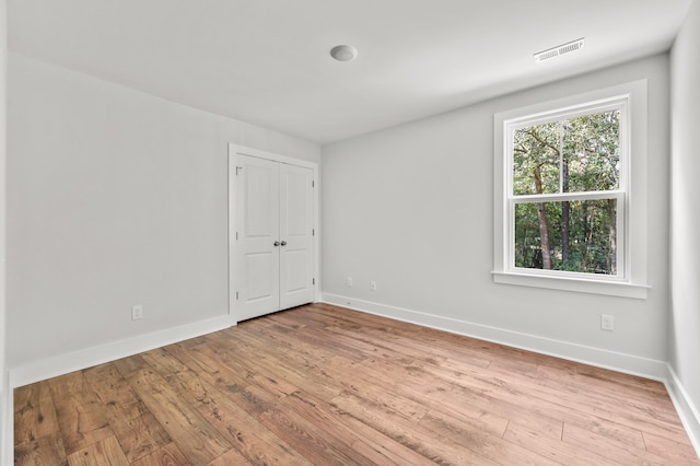 spare room featuring light hardwood / wood-style flooring