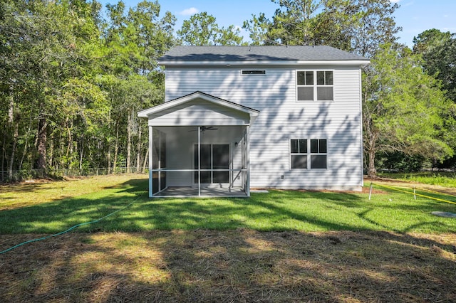 back of property featuring a sunroom and a yard