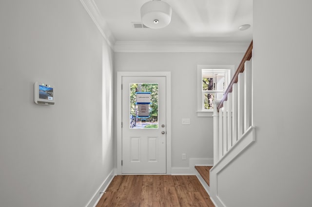 entryway featuring ornamental molding and wood-type flooring