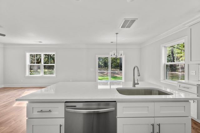 kitchen with stainless steel dishwasher, white cabinetry, sink, and light hardwood / wood-style flooring