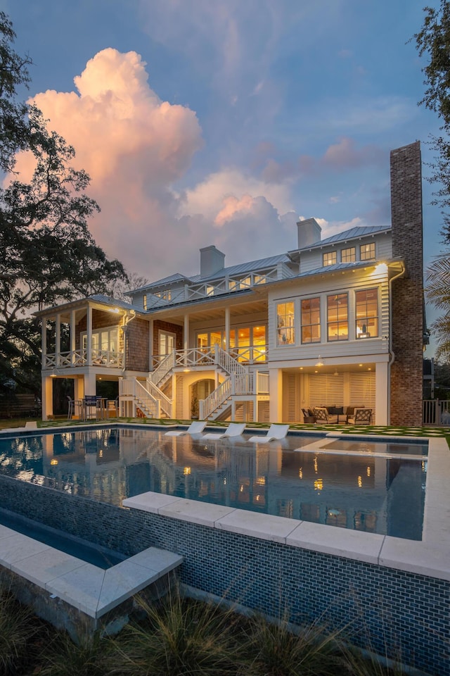 view of pool at dusk