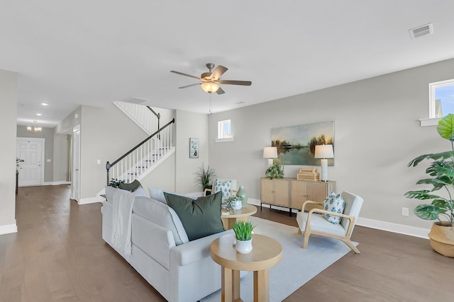 living room featuring ceiling fan and hardwood / wood-style floors