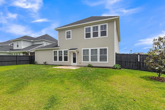 rear view of house featuring a patio area and a yard