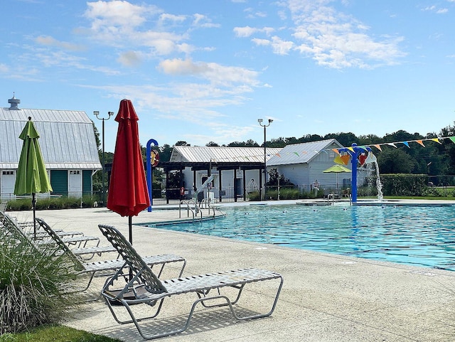 view of pool featuring pool water feature and a patio