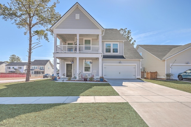 view of front facade featuring a porch, a balcony, a garage, and a front yard