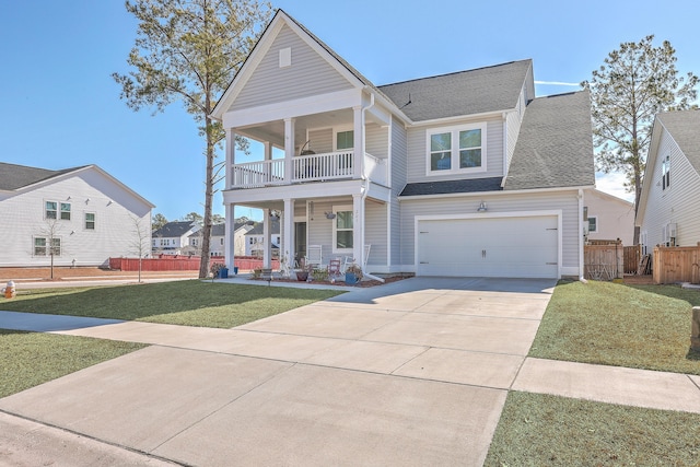 view of front facade with a garage, a balcony, a porch, and a front lawn