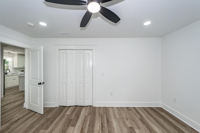 2219 Eagle Dr, North Charleston, SC 29406 - unfurnished bedroom with a sink, baseboards, wood finished floors, visible vents, and a closet