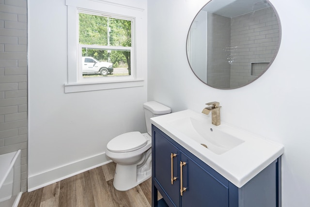 2219 Eagle Dr, North Charleston, SC 29406 - bathroom with vanity, wood finished floors, toilet, baseboards, and a bath