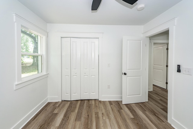 2219 Eagle Dr, North Charleston, SC 29406 - unfurnished bedroom with baseboards, ceiling fan, a closet, and wood finished floors