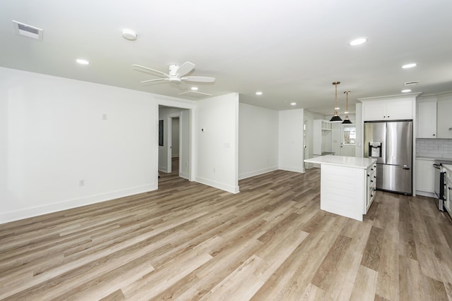 2219 Eagle Dr, North Charleston, SC 29406 - kitchen with visible vents, light countertops, stainless steel fridge with ice dispenser, baseboards, and open floor plan