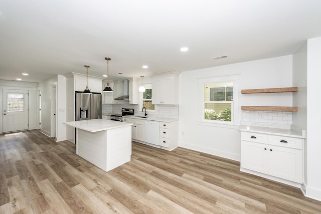 2219 Eagle Dr, North Charleston, SC 29406 - kitchen with wall chimney range hood, light countertops, backsplash, and stainless steel appliances