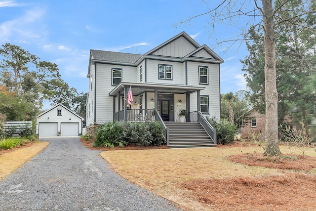 view of front of home featuring an outbuilding, a garage, and a porch