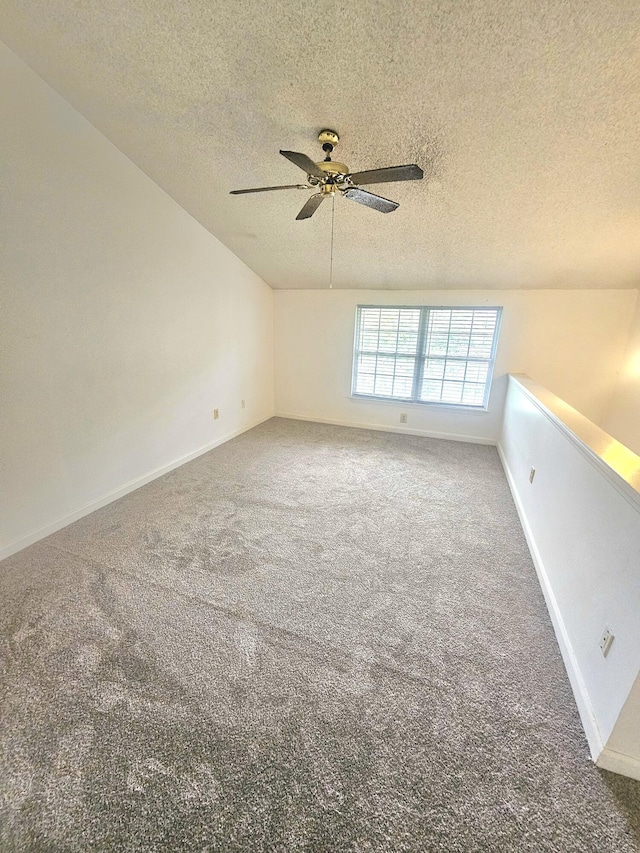 2494 Etiwan Ave Unit 9-D, Charleston, SC 29414 - spare room featuring a textured ceiling, carpet floors, a ceiling fan, lofted ceiling, and baseboards