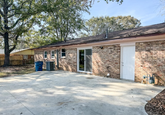 back of house with central air condition unit and a patio area