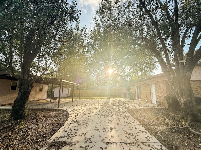 view of home's community featuring a patio and a carport