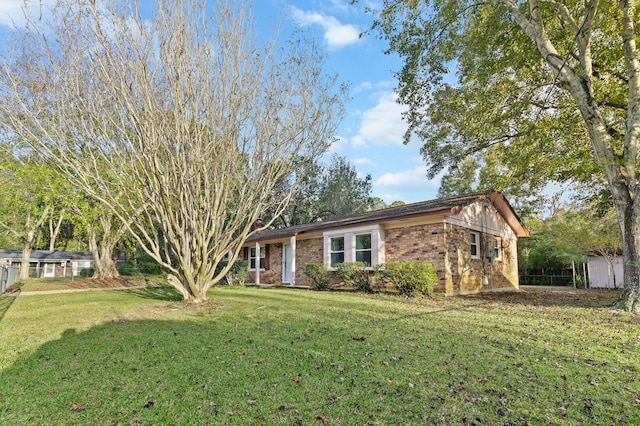 view of front facade featuring a front yard and a storage unit