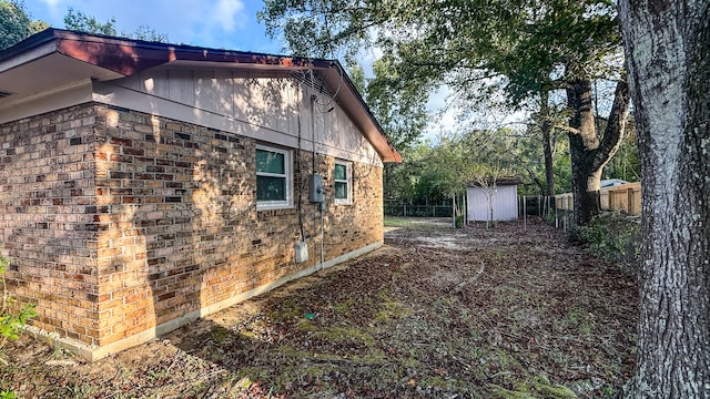 view of home's exterior featuring a storage unit