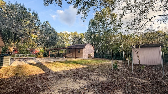 view of yard with a storage unit, central AC, and a patio area