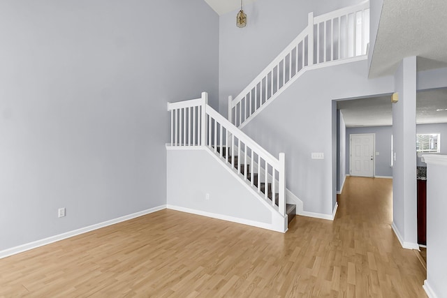 230 Darcy Ave, Goose Creek, SC 29445 - staircase with wood finished floors, baseboards, and a towering ceiling