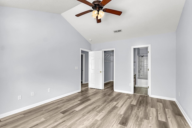 230 Darcy Ave, Goose Creek, SC 29445 - unfurnished bedroom featuring wood finished floors, baseboards, a closet, a walk in closet, and high vaulted ceiling