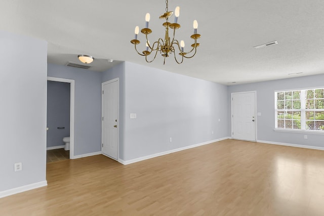 230 Darcy Ave, Goose Creek, SC 29445 - spare room featuring light wood-style floors, a chandelier, and baseboards