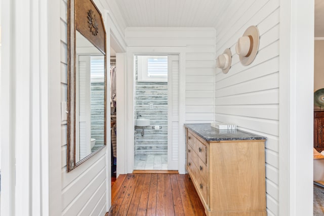 bathroom featuring wood walls and hardwood / wood-style flooring